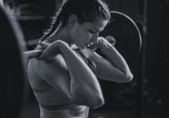 Woman weightlifting with barbell at gym
