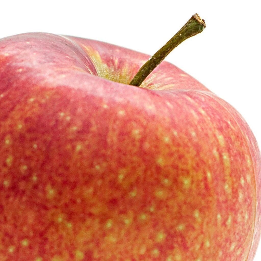 Close-up of a red apple with a visible stem to Get in the Rezzi Zone with organic resveratrol supplements for high performing men with quercitin from apples
